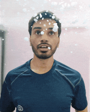 a man with snowflakes on his face wears a blue shirt