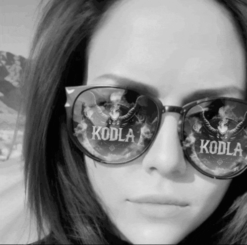 a woman wearing sunglasses with the word koda on the lenses