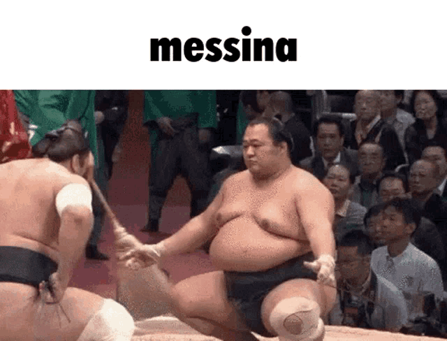 two sumo wrestlers are wrestling in front of a crowd and the word messina is on the bottom of the image .
