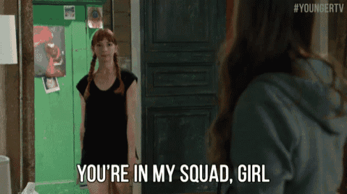 a woman says " you 're in my squad girl " in front of a green door