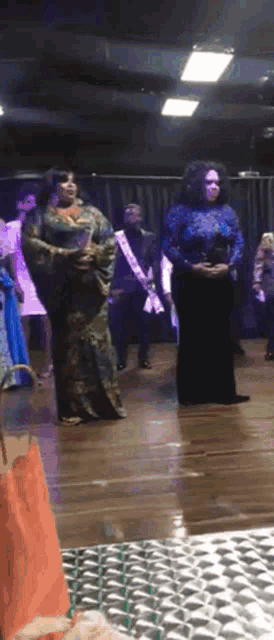 a group of women are standing on a stage with one wearing a sash that says miss texas