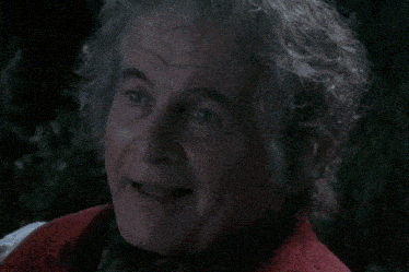 a man with gray hair and a red jacket has a pipe in his mouth