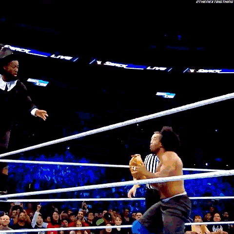 a man is jumping in the air while holding a trophy in his hands .