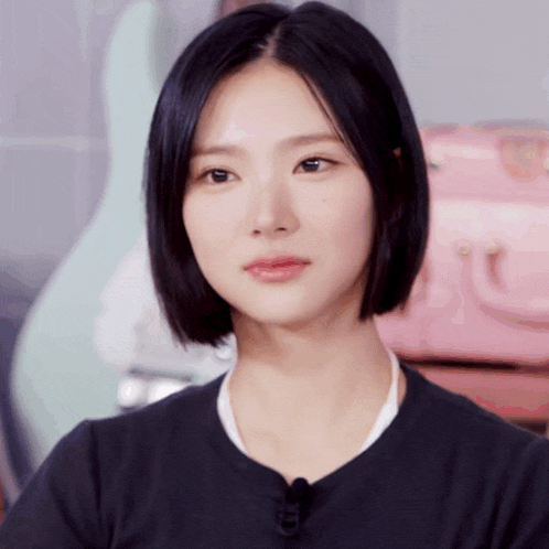 a close up of a woman 's face with a guitar in the background