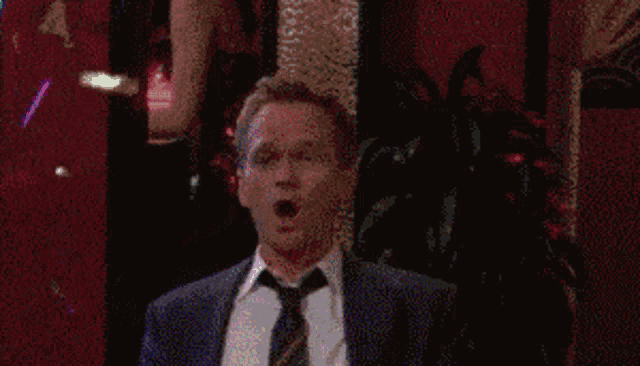 a man in a suit and tie is celebrating with confetti