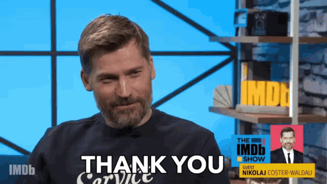 a man with a beard wearing a shirt that says " thank you "