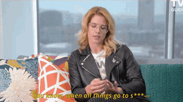 a woman wearing glasses and a leather jacket says you know when all things go to ***