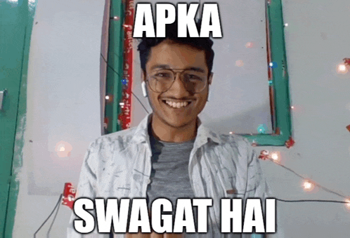 a young man wearing glasses is smiling with the caption apka swagat hai