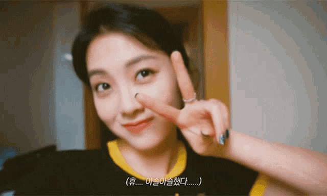 a woman making a peace sign with her fingers on her nose