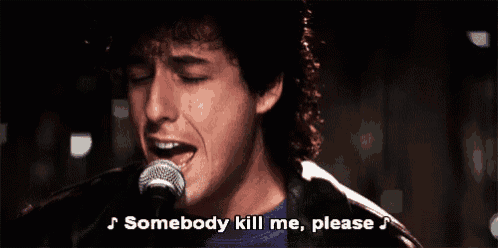 a man singing into a microphone with the words somebody kill me please