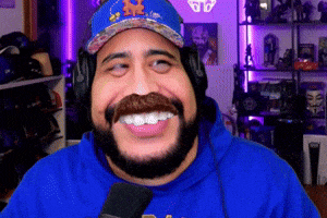 a man with a beard wearing a blue hat and headphones