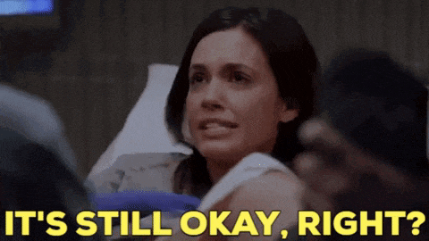 a woman laying in a hospital bed with the words it 's still okay right behind her