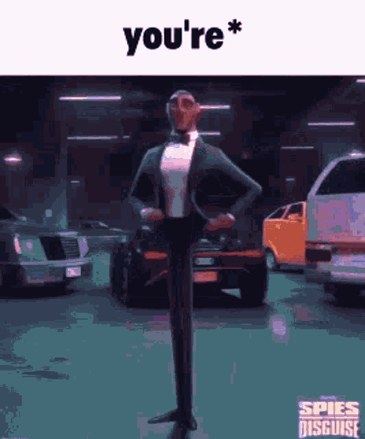 a man in a tuxedo and bow tie is standing in a parking garage with cars .