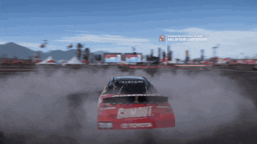 a toyota race car is driving down a track
