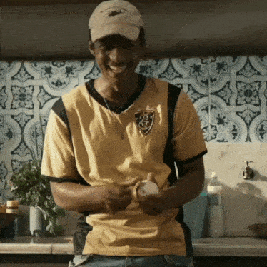 a man wearing a hat and a yellow shirt that says fcg on it
