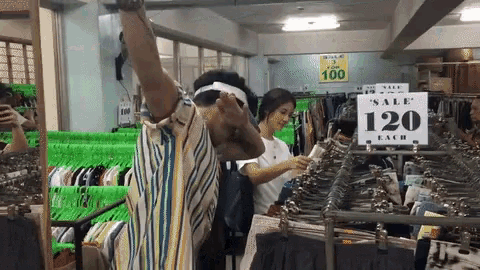 a man wearing a white headband is standing in front of a sign that says sale 120 each