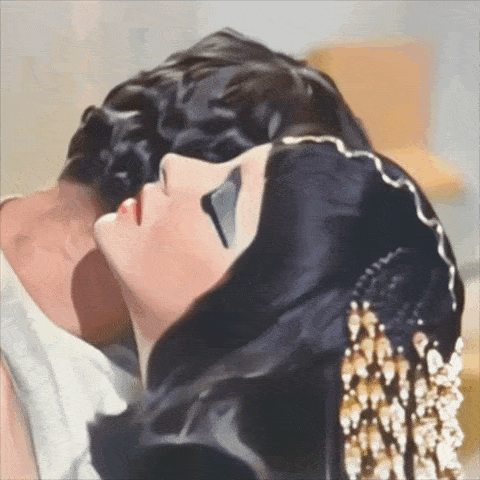 a painting of a man and woman kissing with the woman wearing a black headpiece