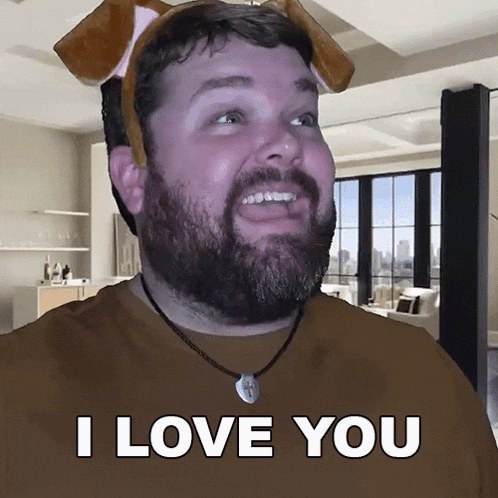 a man with a beard wearing a dog headband says " i love you "