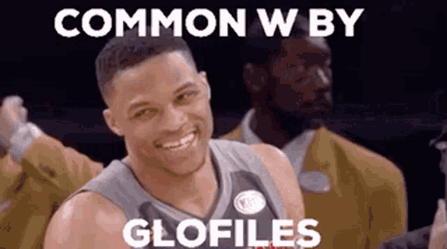 a basketball player is smiling and looking at the camera with the words `` common w by glofiles '' .