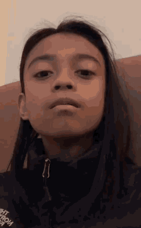a girl wearing a black jacket with the word north face on it