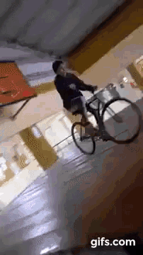 a person is riding a bike down a set of stairs with a gifs.com logo in the corner