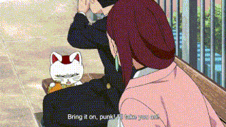 a man and a woman are sitting on a bench with a cat on the man 's back .