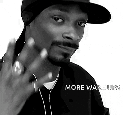 a black and white photo of snoop dogg with the words more wake ups on the bottom