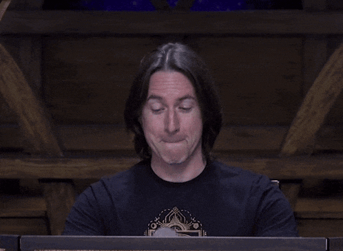 a man in a black shirt is smiling with the words oh boy above him