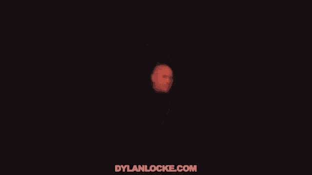 a close up of a bald man 's head with a red glow coming out of it .