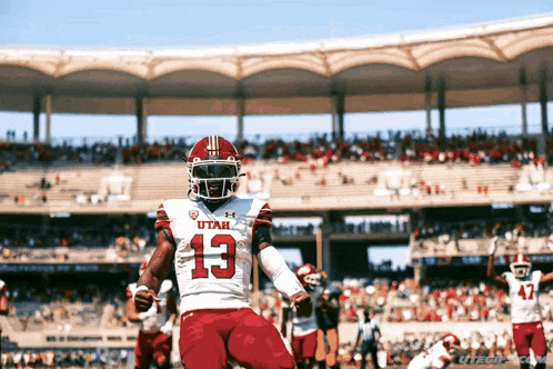 a football player wearing a utah jersey number 13