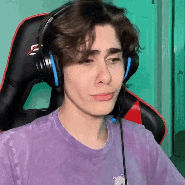 a young man wearing headphones and a tie dye shirt