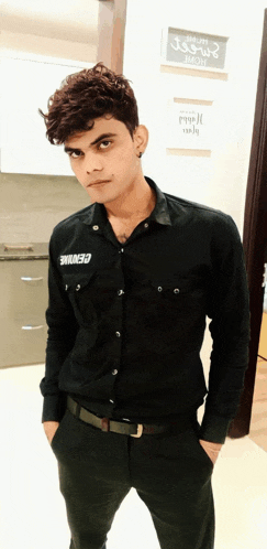 a man wearing a black shirt with the word genuine on the front