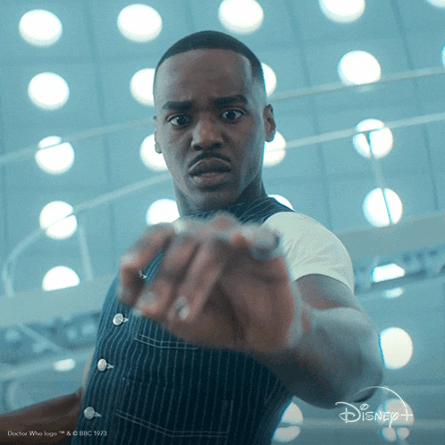 a man with a disney logo on the bottom of his shirt