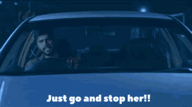 a man is driving a car with the words just go and stop her