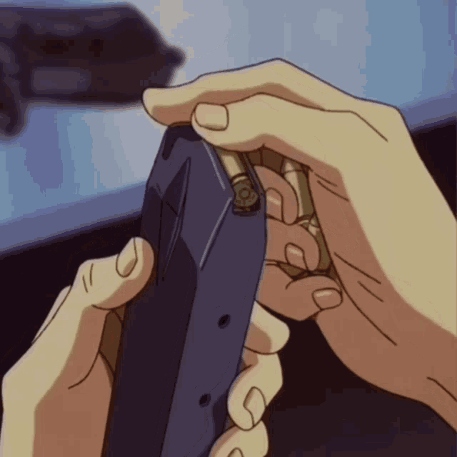 a close up of a person 's hand holding a gun magazine