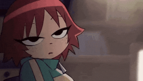 a cartoon girl with red hair is making a funny face .