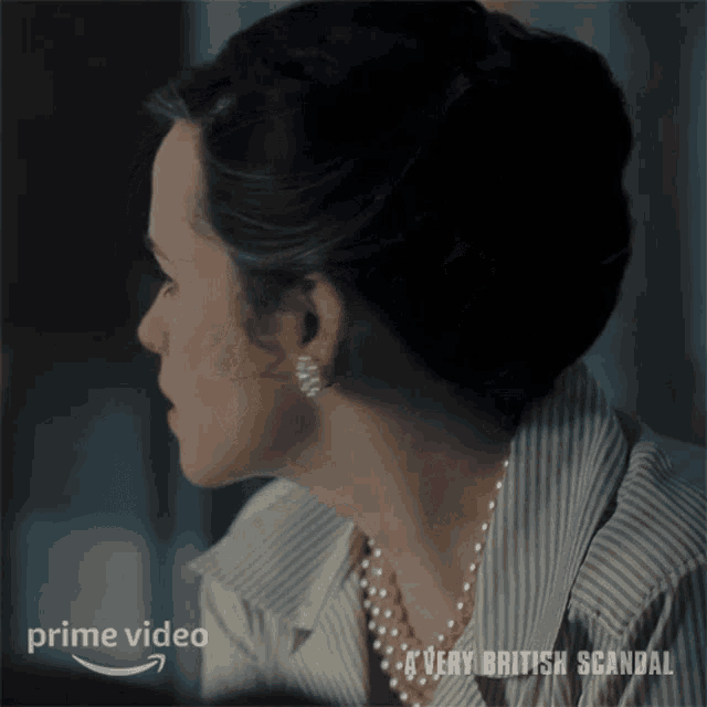 a woman wearing a pearl necklace and earrings is in a prime video ad
