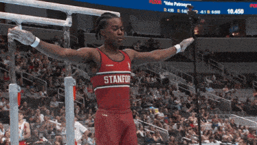 a man in a stanford uniform is doing a trick