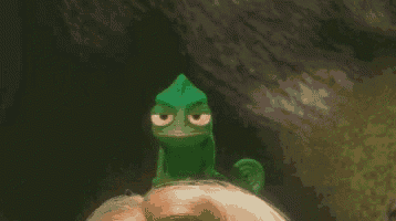 a green chameleon is sitting on a woman 's head .