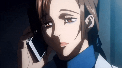 a woman is talking on a cell phone while wearing a blue shirt .