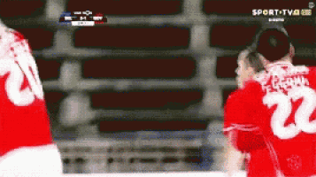 a soccer player wearing a red jersey with the number 22 on it