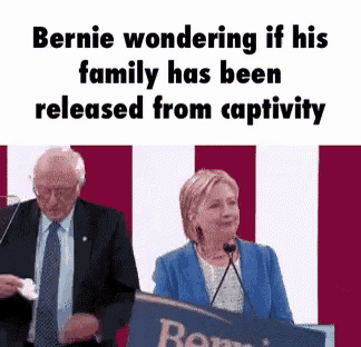bernie wondering if his family has been released from captivity while hillary is giving a speech