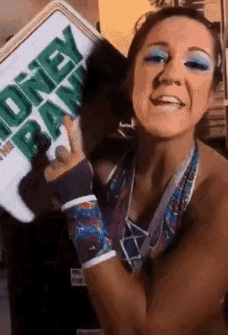 a woman with blue eye shadow is holding a cooler that says money bank on it .