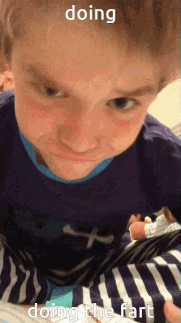 a child laying on a bed with the words doing doing the fart