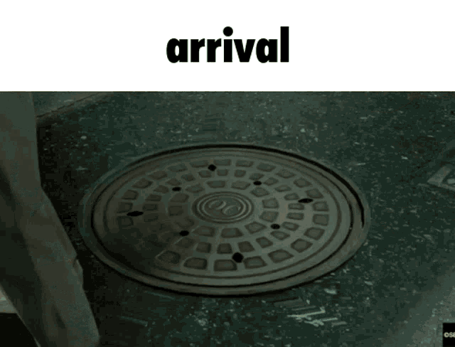a picture of a manhole cover and the word arrival