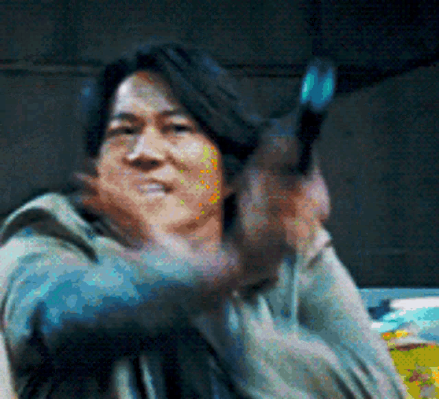 a man is pointing a gun at the camera in a pixelated image