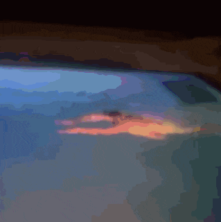 a blurry picture of a person swimming in a pool at night