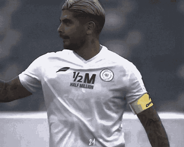 a soccer player wearing a white jersey that says 1/2 m half million