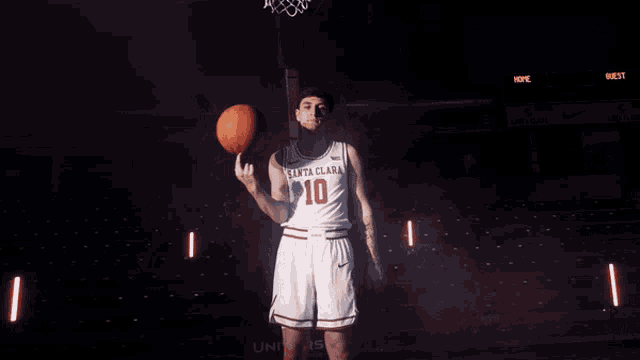 a basketball player from santa clara holds a basketball in his hand