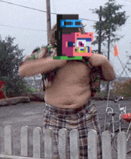 a shirtless man is holding a block with the letter e on it